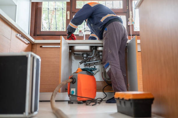 plumber-unclogging-a-kitchen-sin