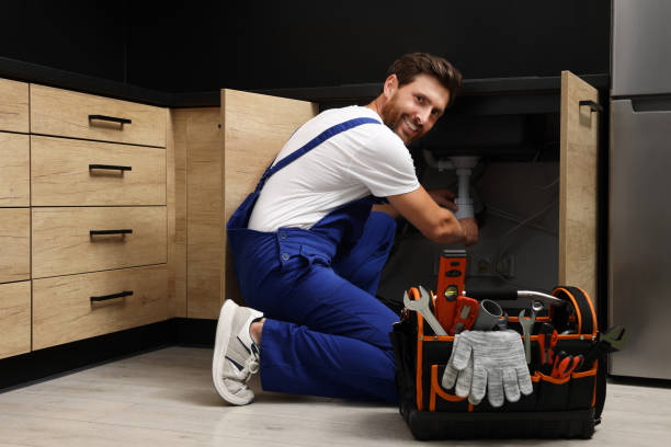 Professional plumber in uniform fixing sink indoors Solve Your Plumbing Issues Fast