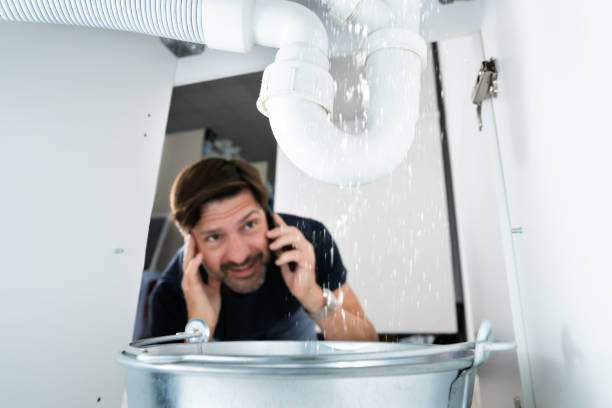 Worried Man Calling Plumber While Watching Water Leaking From Sink Sparky Plumbing: Your Trusted Certified Plumbers in Hollywood, FL